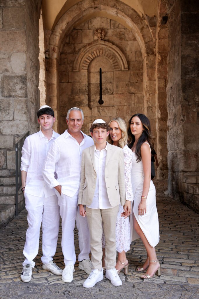 Celebrating with family at the Western Wall in Jerusalem, captured by Pais Photos, professional Bar Mitzvah and family photography.