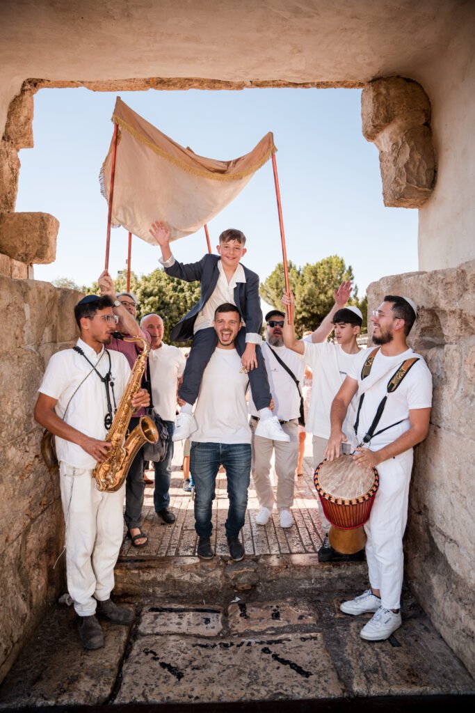 Bar Mitzvah procession at the Dung Gate in Jerusalem, captured by Pais Photos, professional Bar Mitzvah photography preserving family moments.