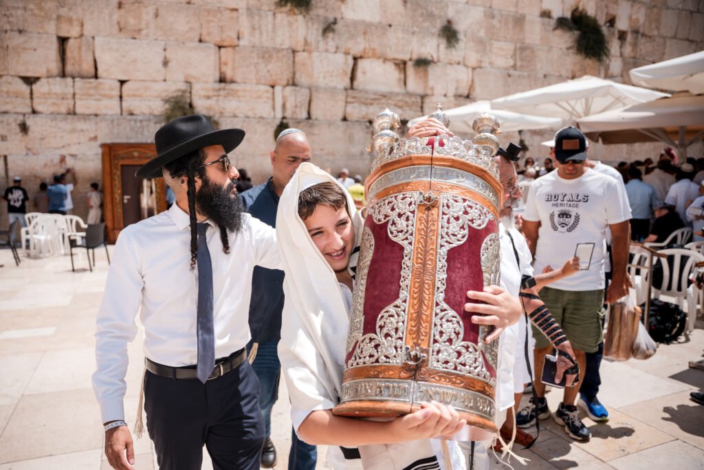 Boy carrying a decorated Torah case in the Western Wall plaza