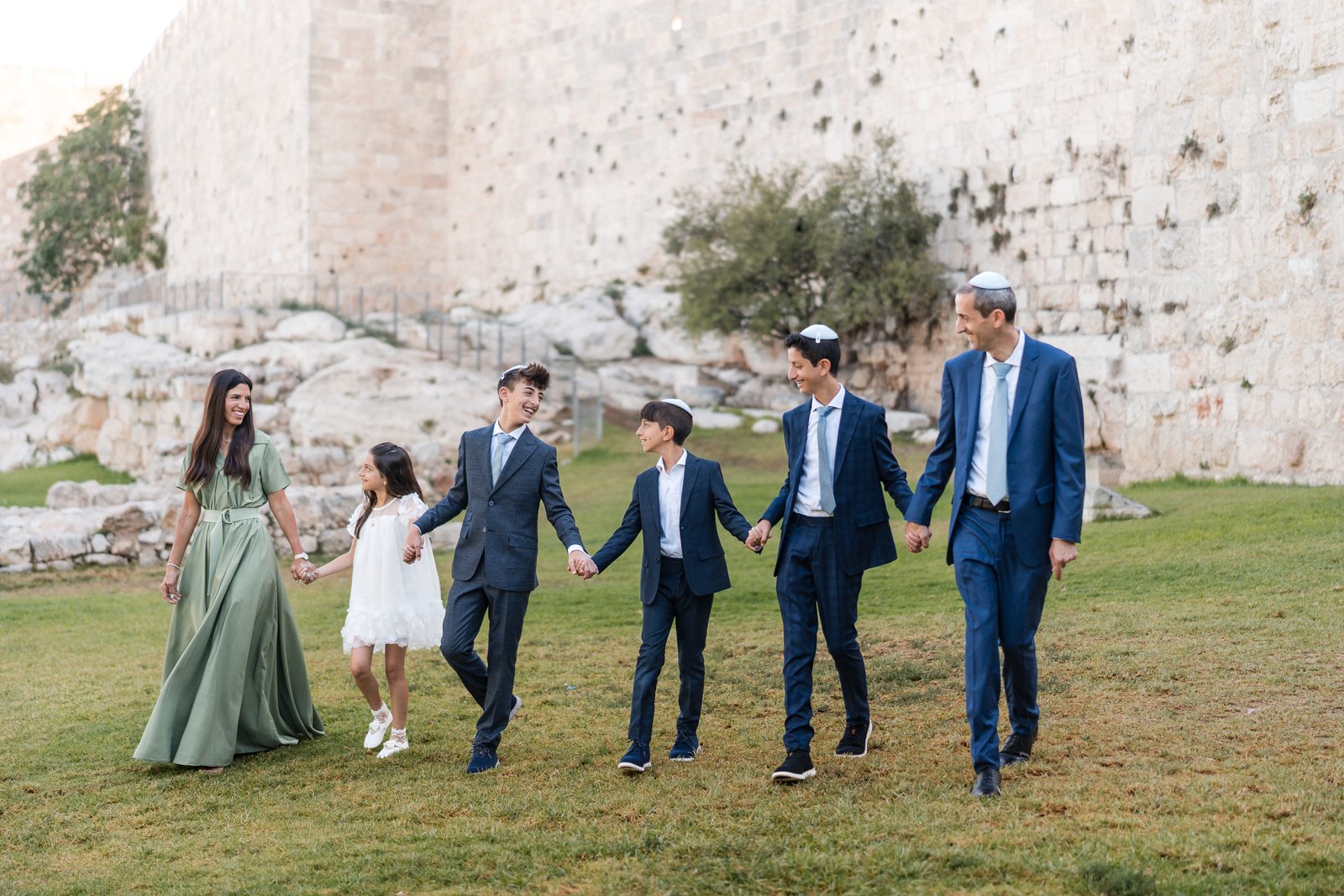 Family photographs beside the walls of Jerusalem