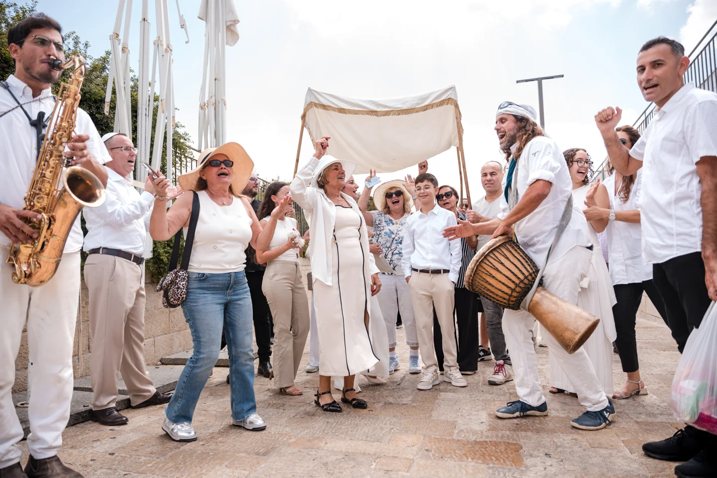 Bar Mitzvah procession with drummers and a tallit canopy outside the Kotel